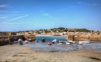 View out through entrance to Marazion harbour, with boats in the foreground